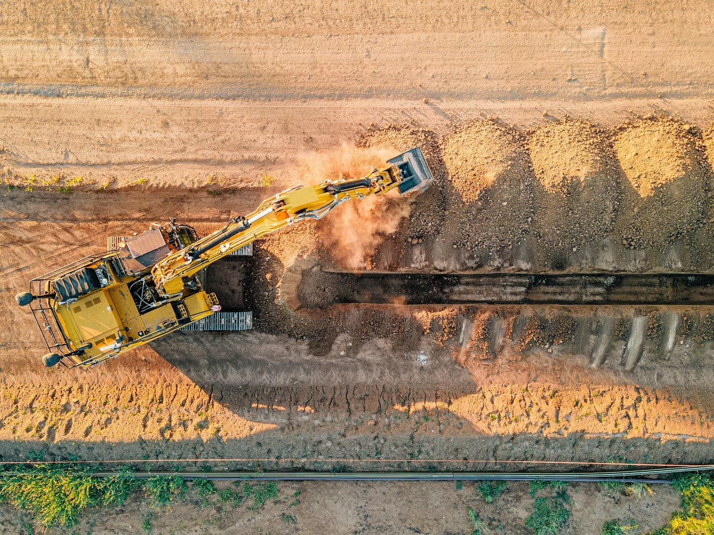 Aerial view of an excavator carrying out bulk earthworks on a development site