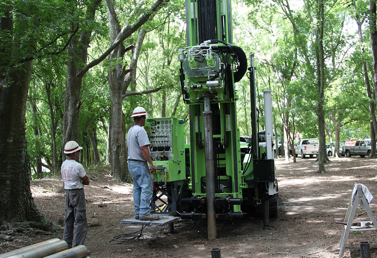 Drilling rig set up for a borehole on a wooded site